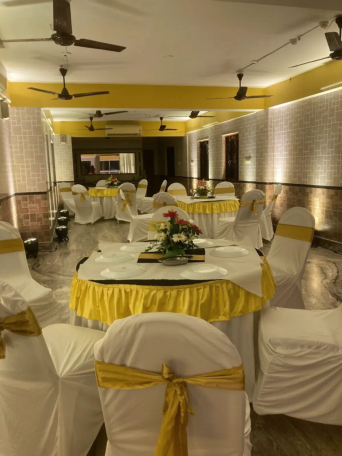 The dining hall laid out with round tables for a full function