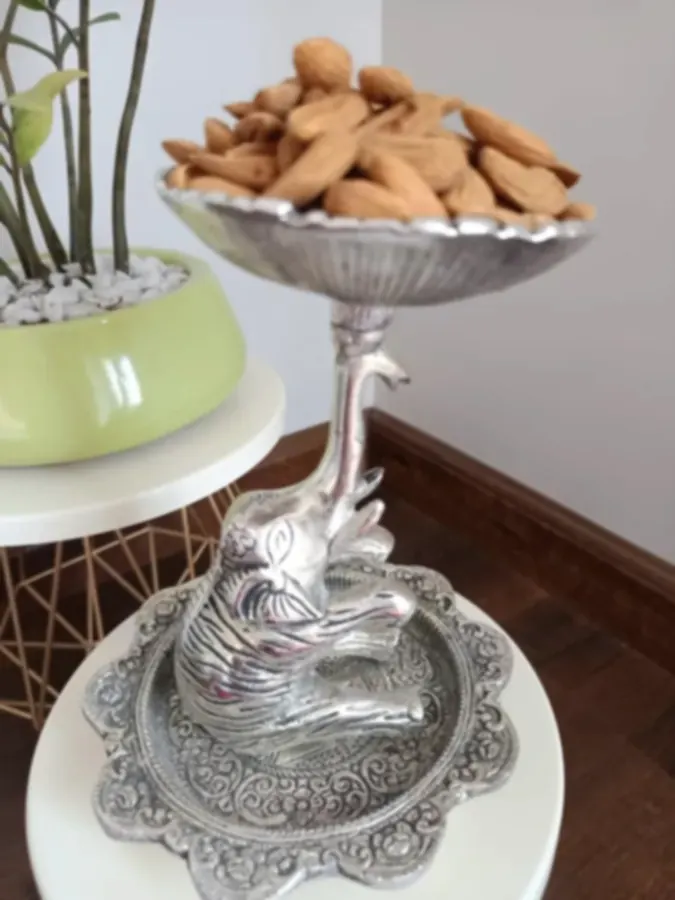 A silver-plated dry-fruit tazza raised on the back of a worked elephant