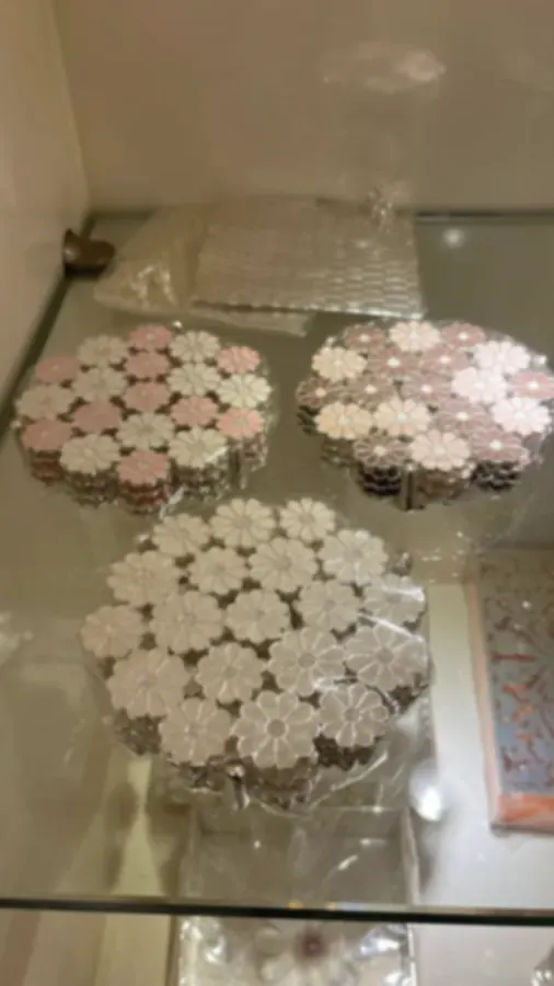Flower-form tealight holders in pale pink and white enamel petals on silver