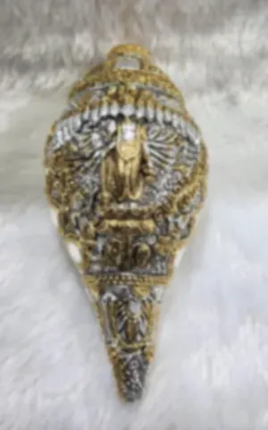A conch shell worked in gold and silver plate with deities in relief