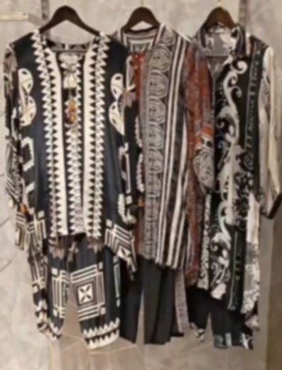 Three black and ivory sets side by side, each in a different bold graphic print: chevrons, broad stripes and a scrolling leaf pattern.