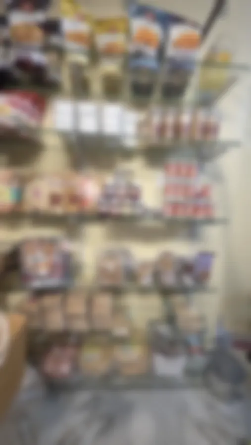 A tall shelf of Copperpot jars and small tubs beside khakhra packets