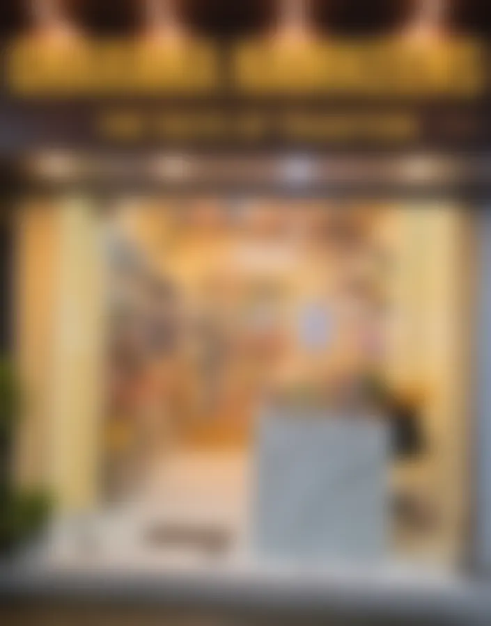 The Copperpot Namkeen House shopfront on Tamarind Lane: gold lettering reading Copperpot Namkeen House, The Taste of Tradition, above a lit glass front and the marble counter inside