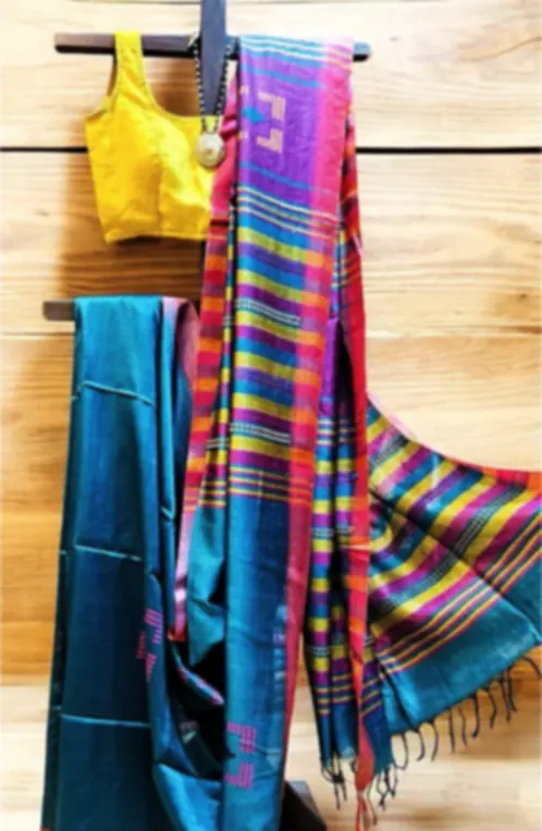 A multicoloured banana silk saree in turquoise, pink and yellow stripes, draped on a stand.