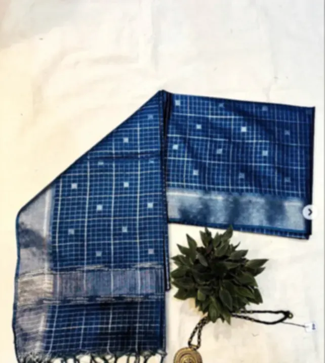 A blue Bhagalpuri viscose silk saree with zari checks and small woven motifs, folded on cream cloth.