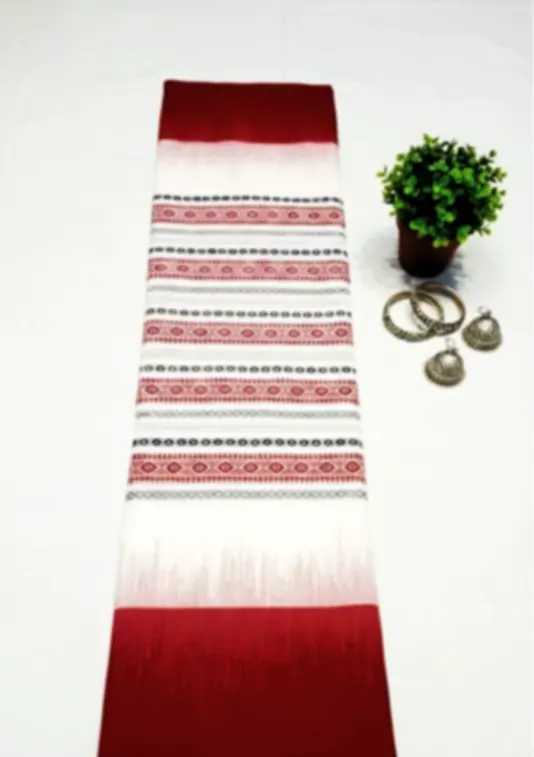 A red and white Dhonekhali cotton saree with a woven striped body, laid out beside brass bangles.