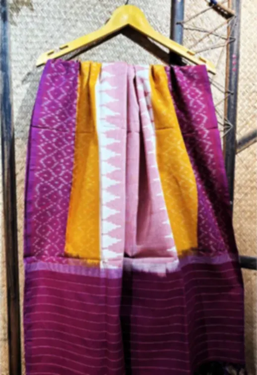 A magenta, yellow and pink Telia cotton dupatta with a purple border, hanging on a wooden rail.