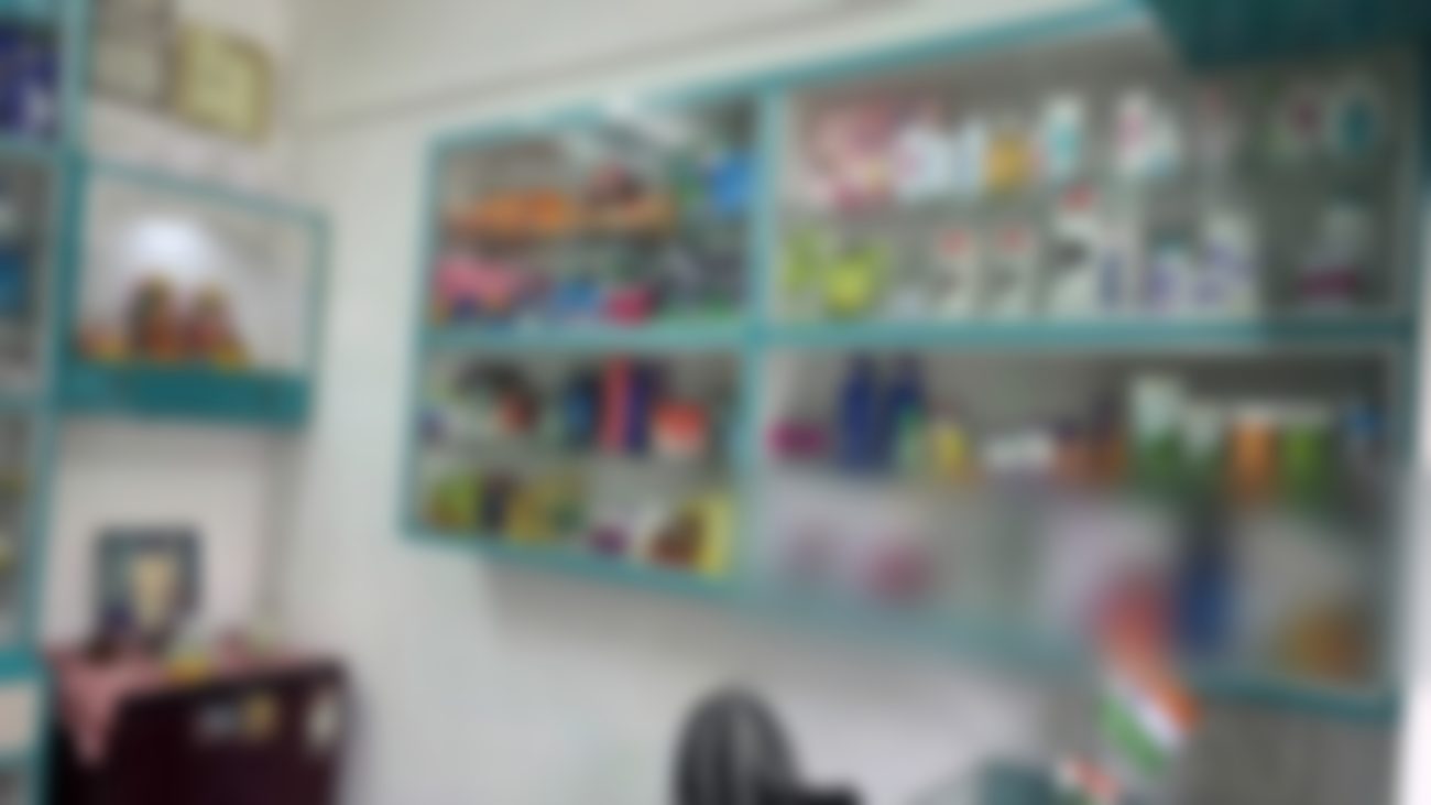 Glass-fronted shelves of toiletries and everyday personal care items