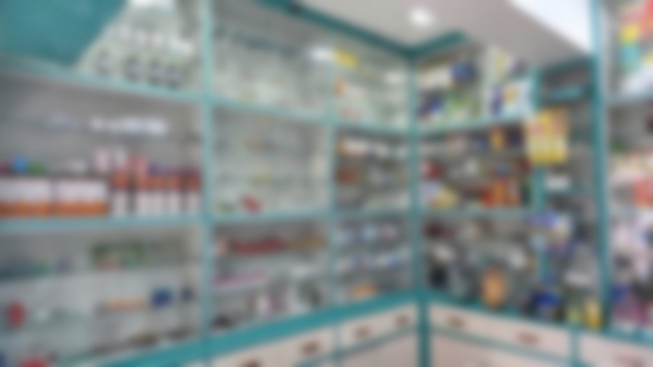 Glass-fronted shelves stocked with medicines